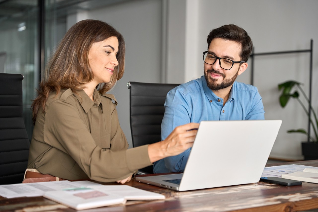 Woman and man looking at laptop