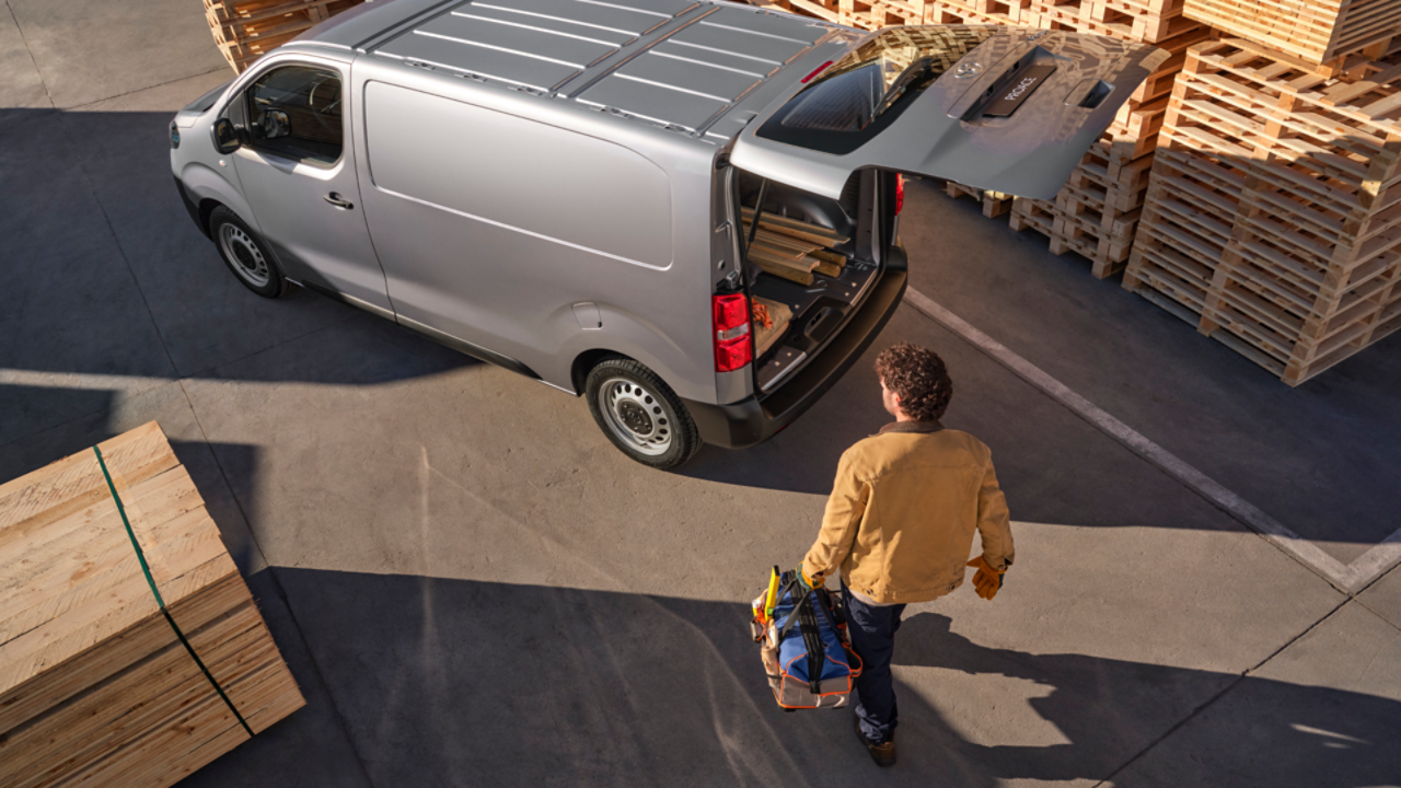 Aerial view of Toyota Proace with workman carrying tool bag