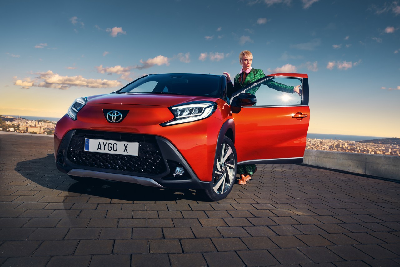 Toyota Aygo X with girl standing in the door